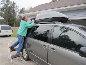 Grandpa helps tie on the trunk.